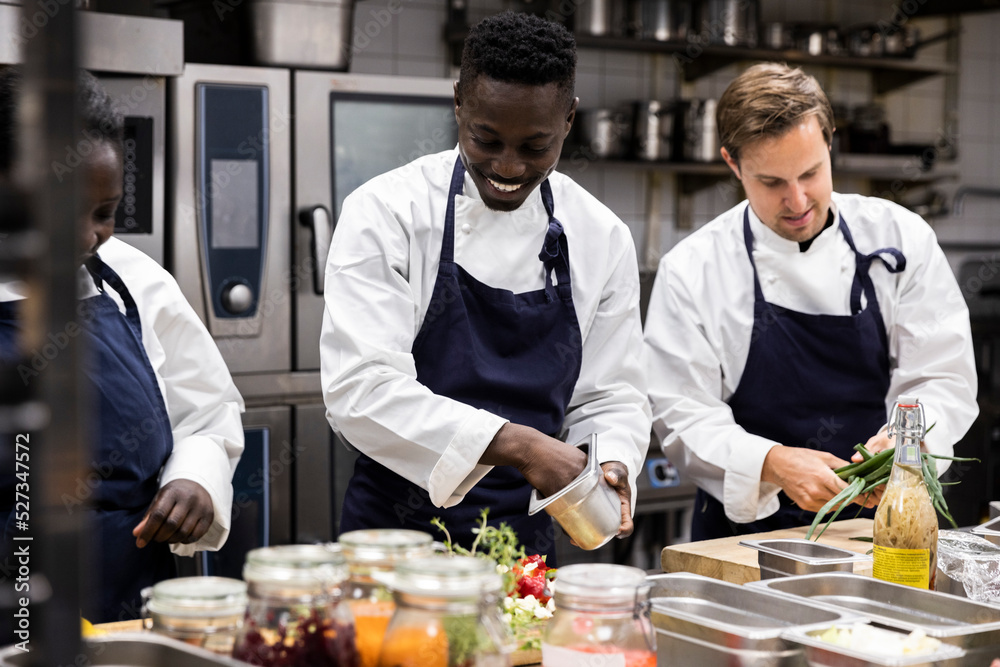 Chefs talking while preparing food in restaurant kitchen Stock Photo ...