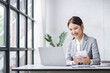 © Daenin - Smiling Asian businesswoman working on laptop in modern office Accountant Concept Finance Expert Analyze Business Report Graph financial chart financial chart corporate economy Banking Market Research