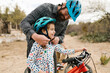 © Tetra Images - Father adjusting daughters (8-9) helmet