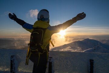 Wall Mural - woman skier looking at sunset above slovakia mountains