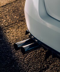 Wall Mural - Exhaust tips sticking out from the rear bumper of a car