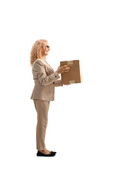 Sticker - Full length profile shot of a mature woman carrying a cardboard box