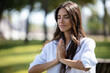 © nenetus - Beautiful young woman doing yoga and meditation in a park.