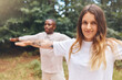 © Jesse B/peopleimages.com - Fitness, zen and yoga couple exercise outdoors in park or forest together, bonding while living a healthy lifestyle. Interracial girlfriend and boyfriend training balance and posture while meditating