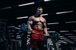 © Fotokvadrat - Muscular man bodybuilder training in gym and posing. Fit muscle guy workout with weights and barbell