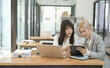 © aekachai - Asian businesswoman using calculator and financial documents at the table office, business financial concept.