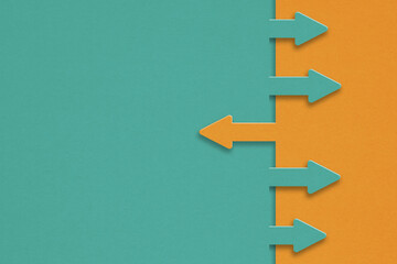 opposite directions arrow paper cut orange and green with copy space for conflict of interest or con