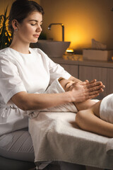 Wall Mural - masseur therapist doing rejuvenating facial massage procedure in a beauty salon. skin care. body car