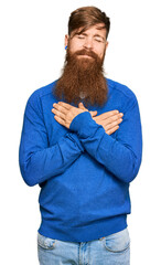 Canvas Print - Young irish redhead man wearing casual clothes smiling with hands on chest with closed eyes and grateful gesture on face. health concept.