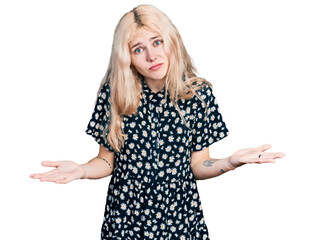 Poster - Young caucasian woman together clueless and confused expression with arms and hands raised. doubt concept.