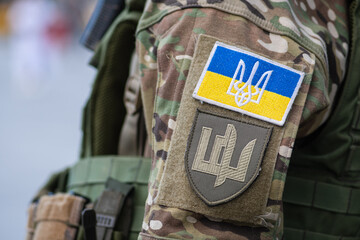 flag of ukraine, ukrainian army or armed forces on a patch of a soldier military uniform, close up