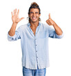 © Krakenimages.com - Young hispanic man wearing summer style showing and pointing up with fingers number six while smiling confident and happy.