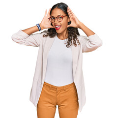 Poster - Young african american girl wearing business clothes smiling cheerful playing peek a boo with hands showing face. surprised and exited