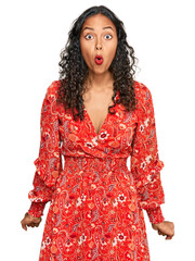 Sticker - Young african american girl wearing summer dress scared and amazed with open mouth for surprise, disbelief face