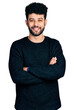 © Krakenimages.com - Young arab man with beard with arms crossed gesture smiling with a happy and cool smile on face. showing teeth.