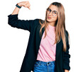 © Krakenimages.com - Hispanic young woman wearing business jacket and glasses strong person showing arm muscle, confident and proud of power