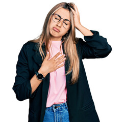 Canvas Print - Hispanic young woman wearing business jacket and glasses touching forehead for illness and fever, flu and cold, virus sick