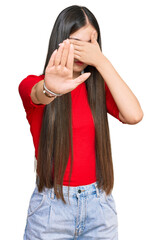 Sticker - Young chinese woman wearing casual clothes covering eyes with hands and doing stop gesture with sad and fear expression. embarrassed and negative concept.