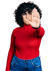 Sticker - Young middle east girl wearing casual clothes and glasses doing stop sing with palm of the hand. warning expression with negative and serious gesture on the face.