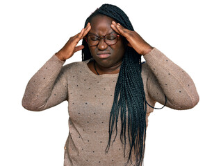 Canvas Print - Young black woman with braids wearing casual clothes and glasses suffering from headache desperate and stressed because pain and migraine. hands on head.