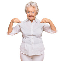 Wall Mural - Senior grey-haired woman wearing casual clothes looking confident with smile on face, pointing oneself with fingers proud and happy.