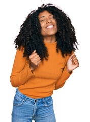 Wall Mural - Young african american girl wearing casual clothes excited for success with arms raised and eyes closed celebrating victory smiling. winner concept.