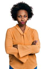 Poster - African american woman with afro hair wearing elegant shirt skeptic and nervous, disapproving expression on face with crossed arms. negative person.