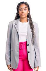 Sticker - Young african american woman with braids wearing business clothes relaxed with serious expression on face. simple and natural looking at the camera.