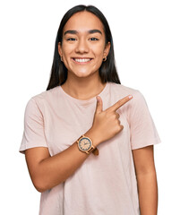 Poster - Young asian woman wearing casual clothes cheerful with a smile of face pointing with hand and finger up to the side with happy and natural expression on face