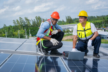 Wall Mural - Engineers checking the operation of the system solar cell on an building in an residential area,Photovoltaic module idea for clean energy production.