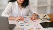 © Prathankarnpap - Professional businesswoman using laptop and working with document on office desk