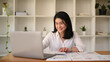 © Prathankarnpap - Professional businesswoman using laptop and working with document on office desk