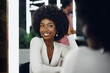 © fotofabrika - Young african woman customer getting a hairstyle at a beauty salon.