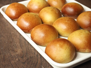 Wall Mural - shiny golden brown baked dinner bread rolls