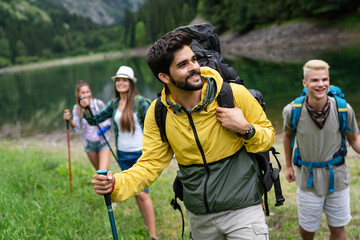 Wall Mural - group of fit healthy friends trekking in the mountains