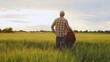 © Acronym - Farmer and his son in front of a sunset agricultural landscape. Man and a boy in a countryside field. Fatherhood, country life, farming and country lifestyle.