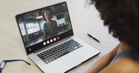 Sticker - African american woman using laptop for video call, with business colleague on screen