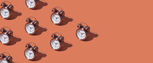 Pattern Of An Alarm Clock On A Colored Background. Monochrome Time Concept. Banner Format.