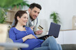 © auremar - couple buying online on the interent with a credit card
