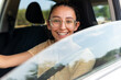 © ADDICTIVE STOCK - Young smiling woman driving modern car