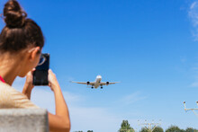 Anonymous Young Woman Taking Photography Of Plane