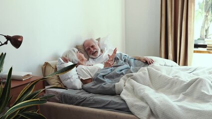 Wall Mural - Elderly couple at home. Old woman and man having fun laughing in bed in the morning. Concept about third age and love	