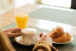 © ADDICTIVE STOCK - Anonymous woman having breakfast in restaurant