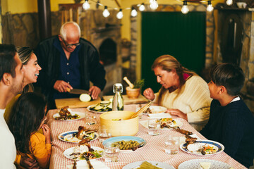 Wall Mural - Happy latin family cooking together during dinner time at home - Focus on boy head