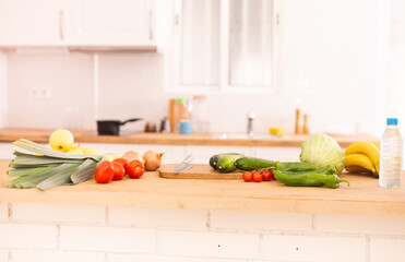 Vegetables and fruits. Onion, tomato, pepper, banana on wooden table in kitchen