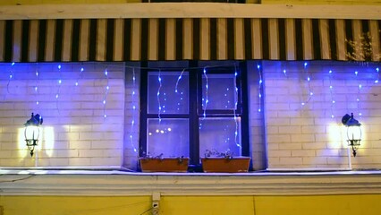 Wall Mural - blue led light holiday illumination on the night window, christmas decoration