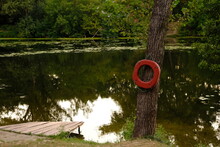 Lifebuoy Ring On Berth Of The River With Wooden Pier Outdoors