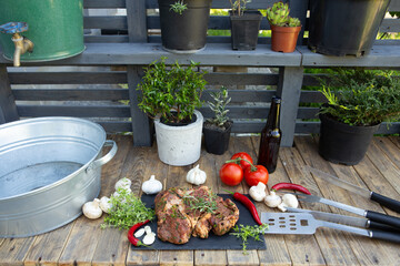 Marinated beef steak on wooden table top. Healthy food concept. Beef cut and spices for cooking bbq sauce outdoors, garden kitchen