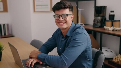 Wall Mural - Young hispanic man business worker smiling confident at office