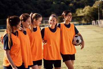 Wall Mural - Embraced female soccer players on playing field.